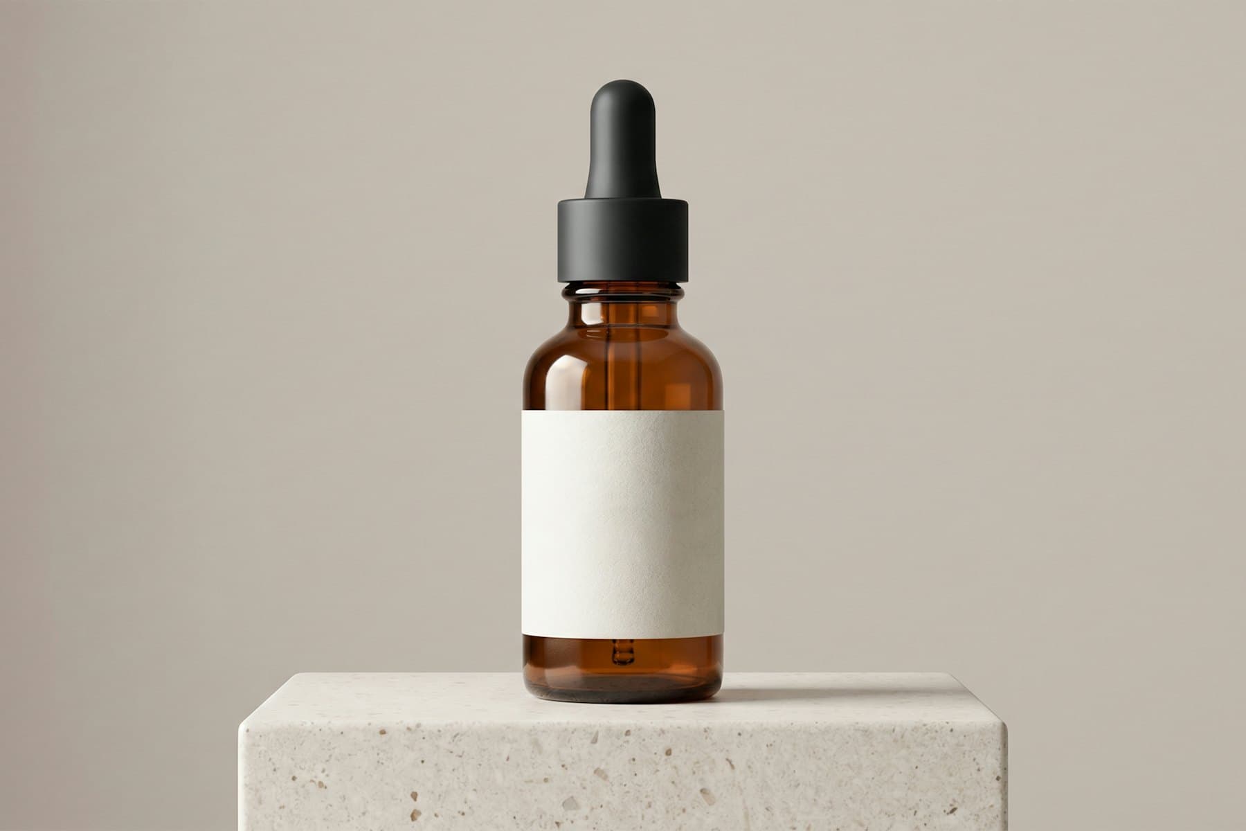 Amber glass supplement bottle on a stone plinth