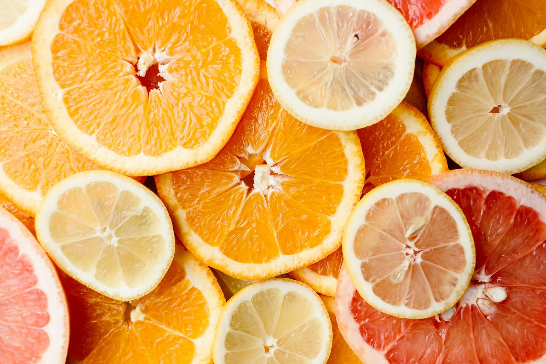 Fresh citrus fruit arranged on a pale surface