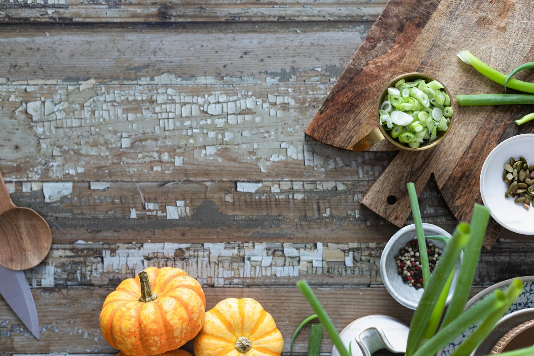 A wooden table of fresh vegetables and whole foods